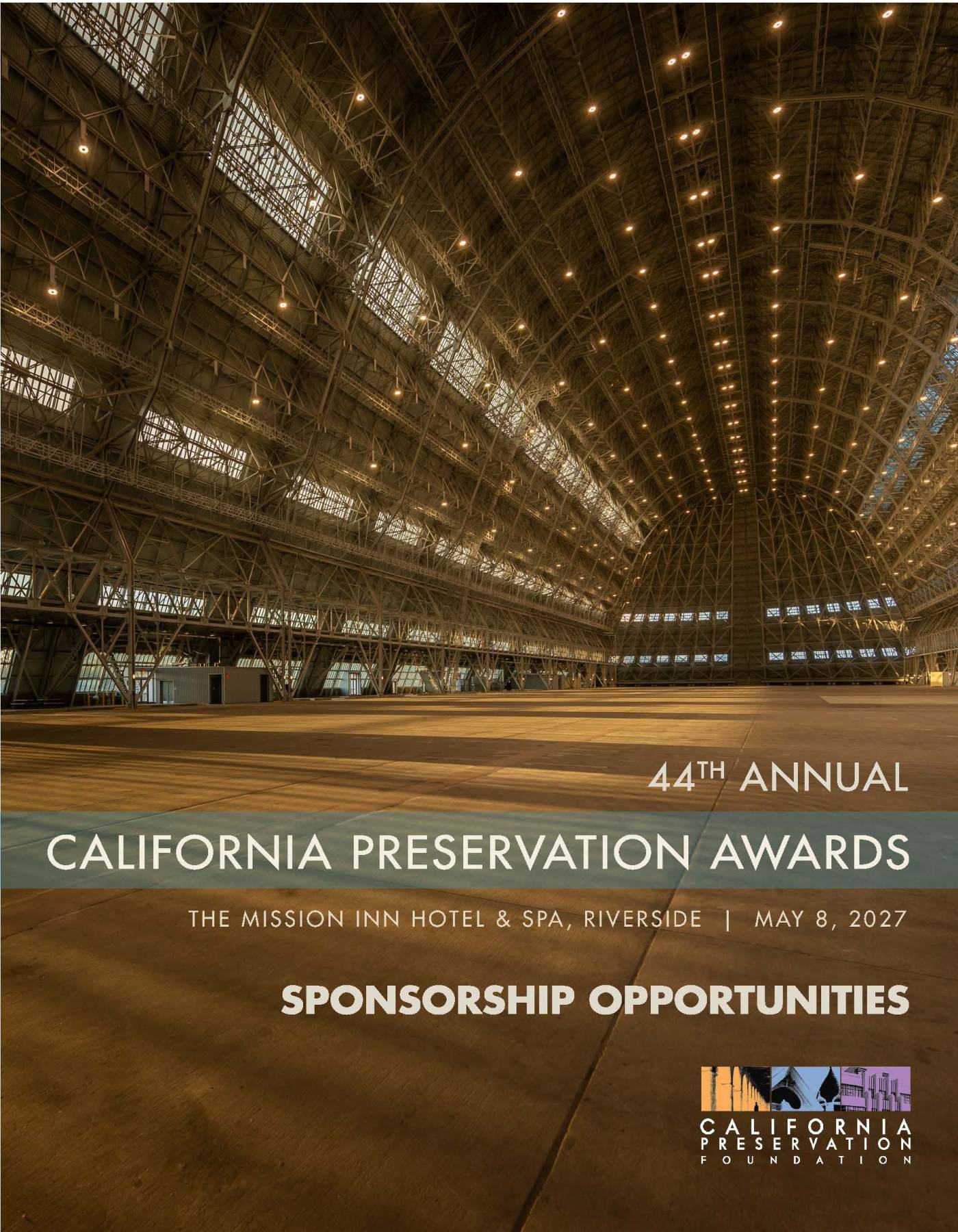 Wide interior view of a large, empty, arched hangar with metal framework and bright ceiling lights. Text announces the 44th Annual California Preservation Awards and sponsorship opportunities for May 8, 2027.