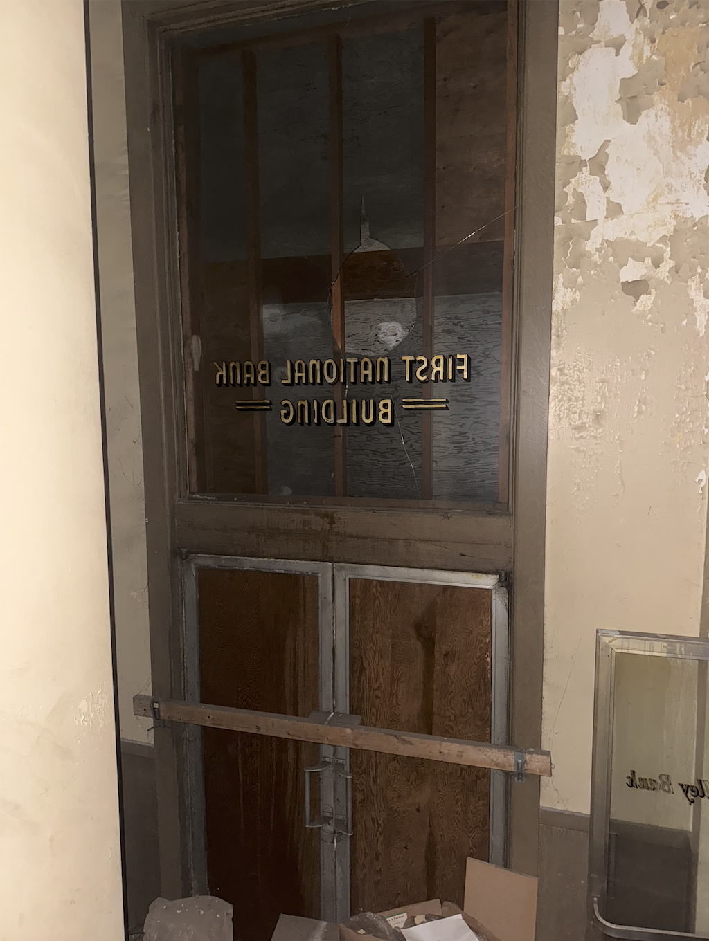 Historic First National Bank lettering on an interior glazed door