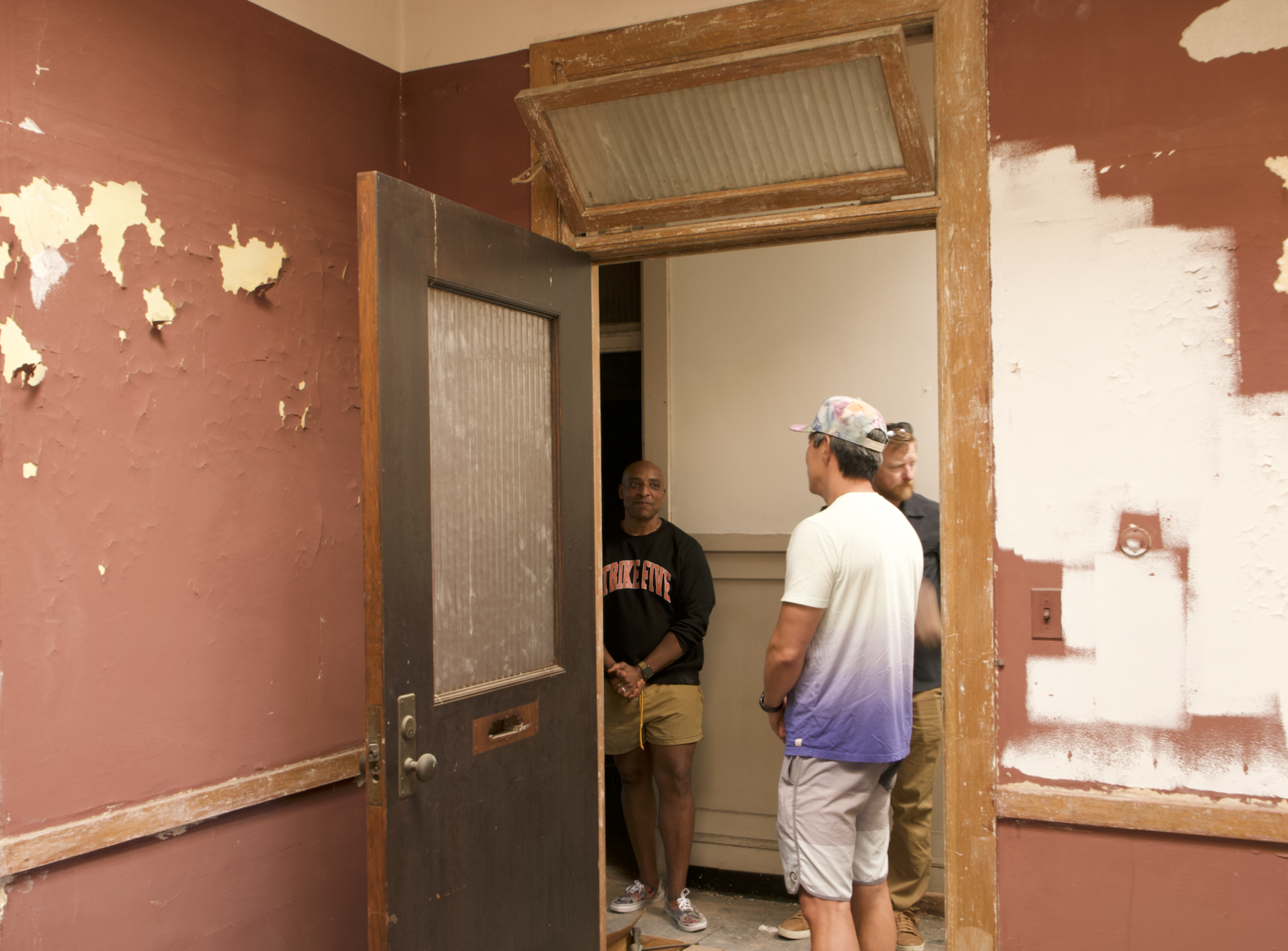 People examining an interior doorway at 530 Macdonald Avenue