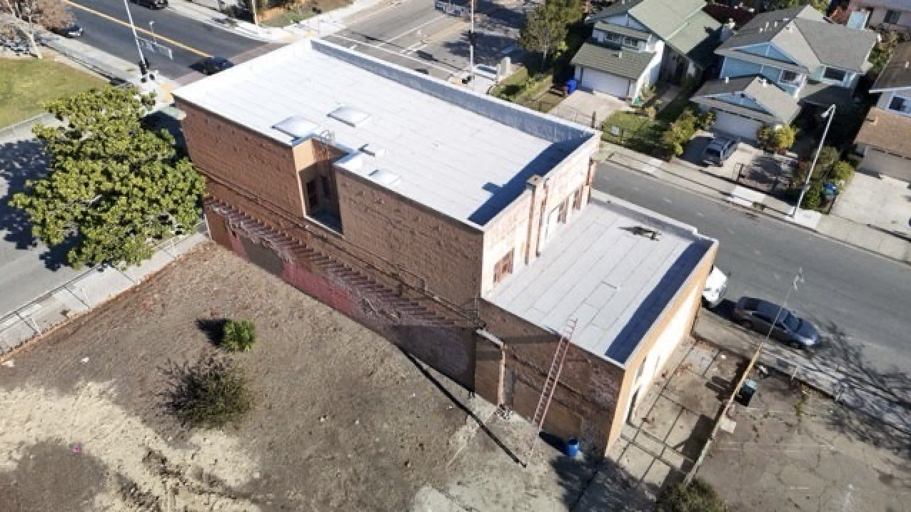 Aerial view of the building, courtyard, and adjoining property at 530 Macdonald Avenue